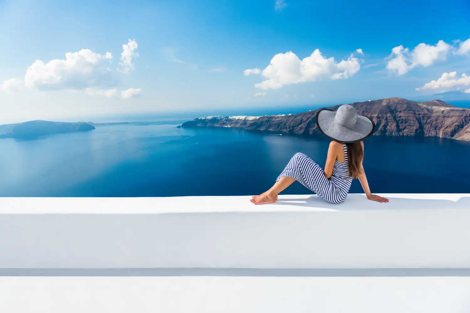 Ferry to Santorini - Europe Greece Santorini travel vacation. Woman looking at view on famous travel destination.
