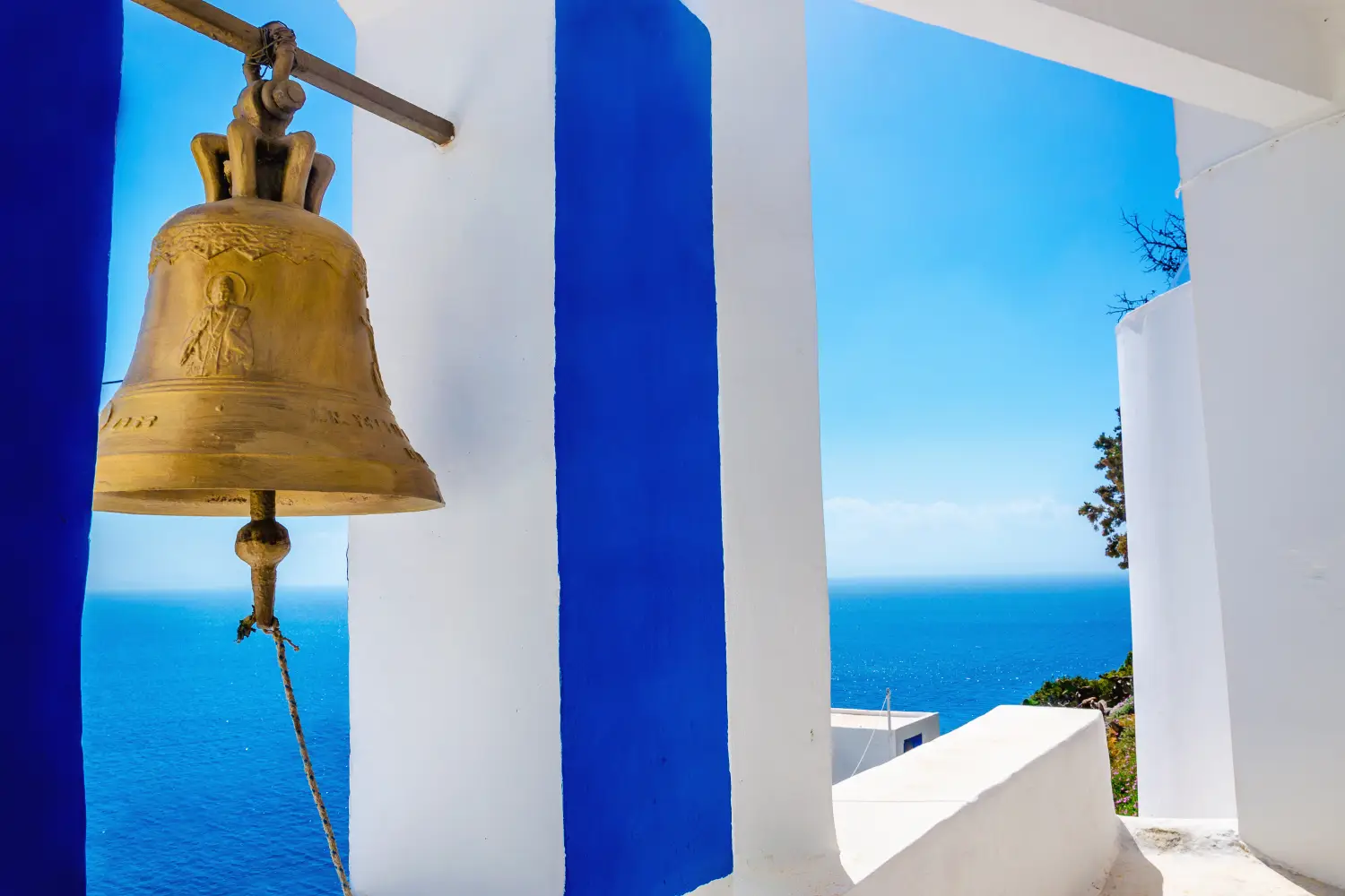 Ferrry to Rhodes - Iconic view on golden bell and typical blue. White church on Greek Island Kalymnos, Greece.