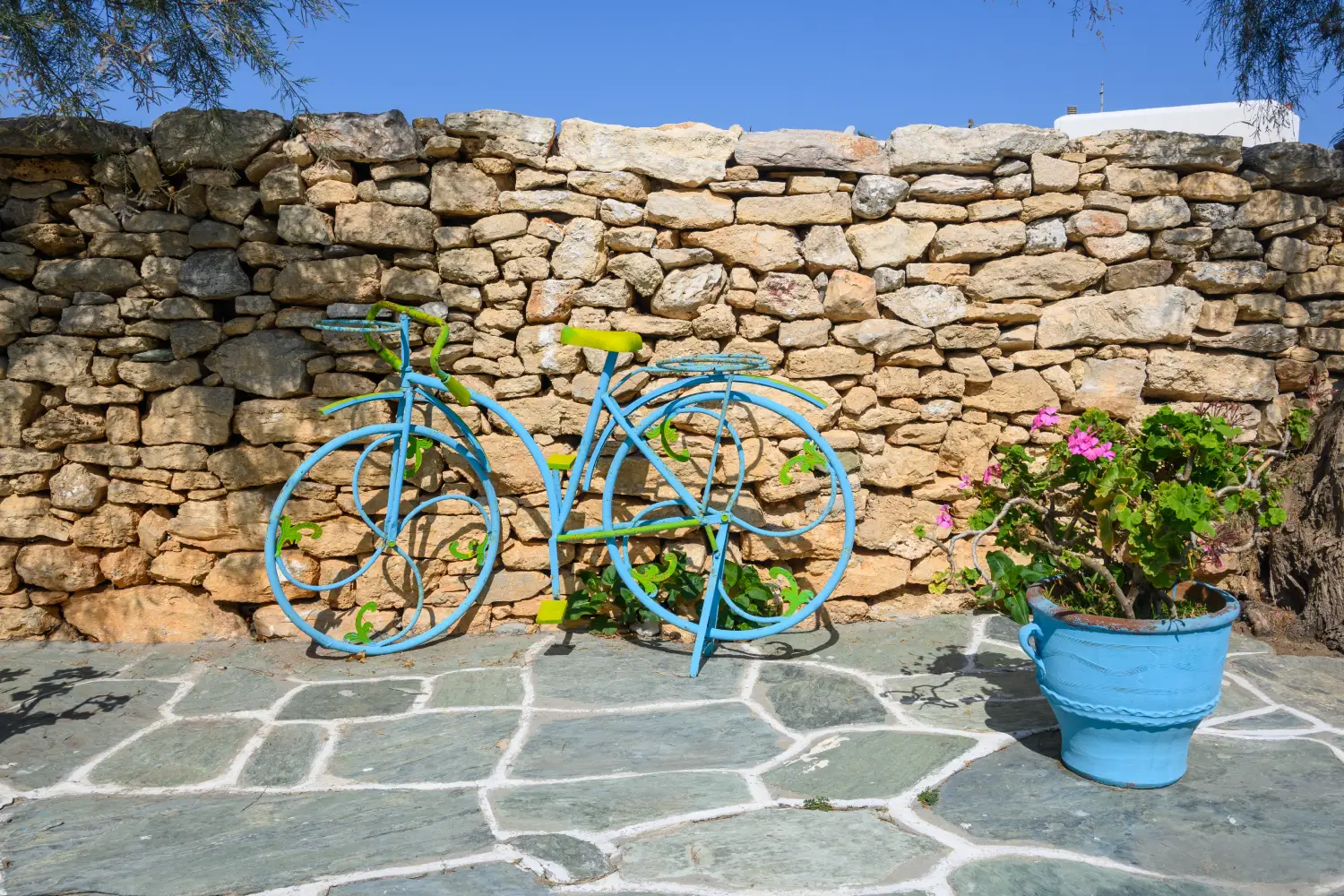 Ferry to Folegandros - Decorative bicycle parked on street in the town of Chora on the island of Folegandros Cyclades, Greece.