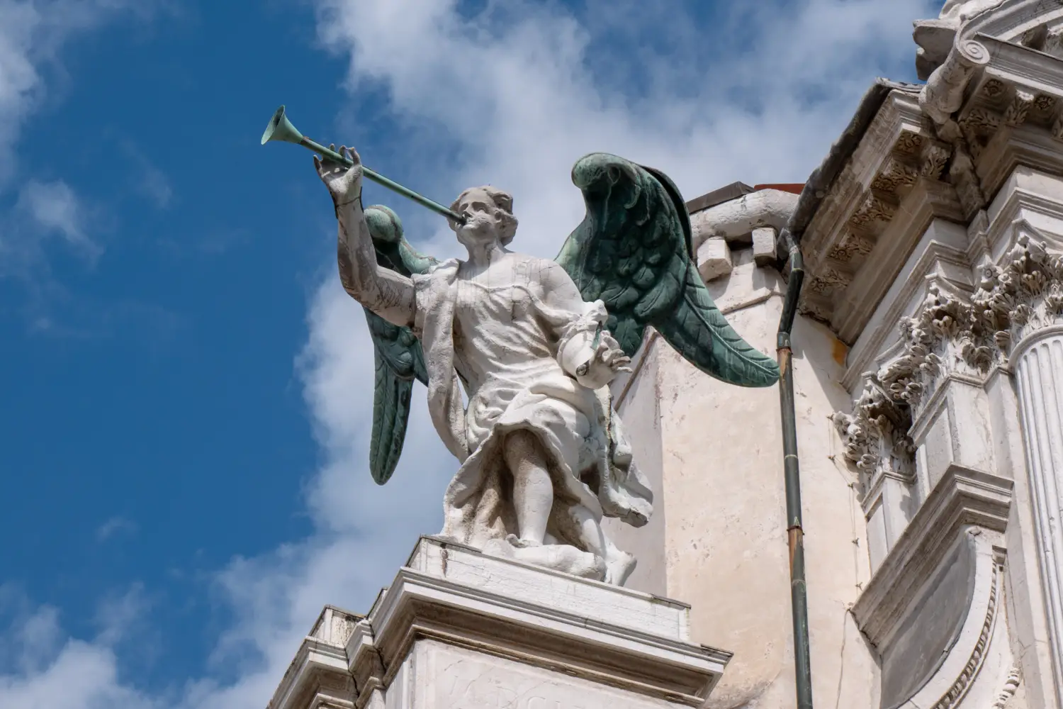 Ferry to Giglio - Details of an Angel with a trumpet at the facade of Santa Maria del Giglio church Santa Maria Zobenigo in Venice, Italy.