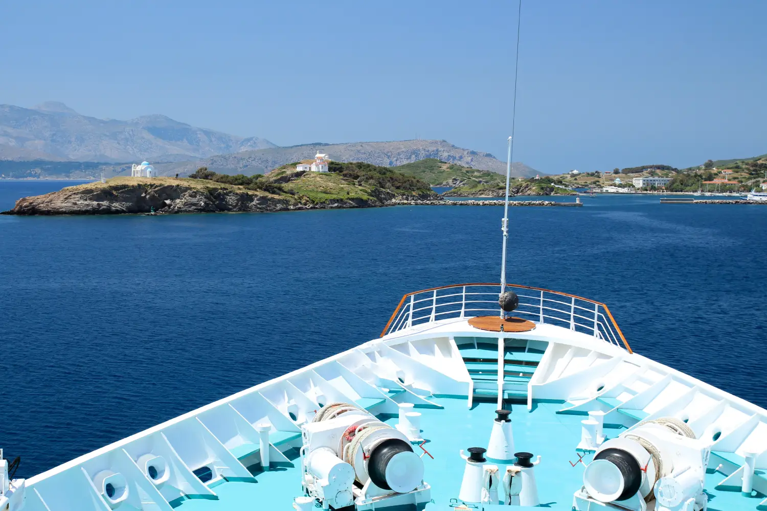 Ferry to Inousses - Bow of a cruise ship with view to Inousses Island Harbour Inousses is a small island in the aegean sea of Greek.