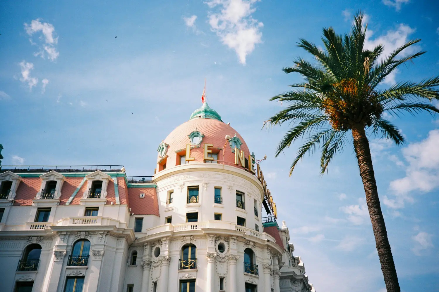 Ferry to Nice - Palm tree in front of building.