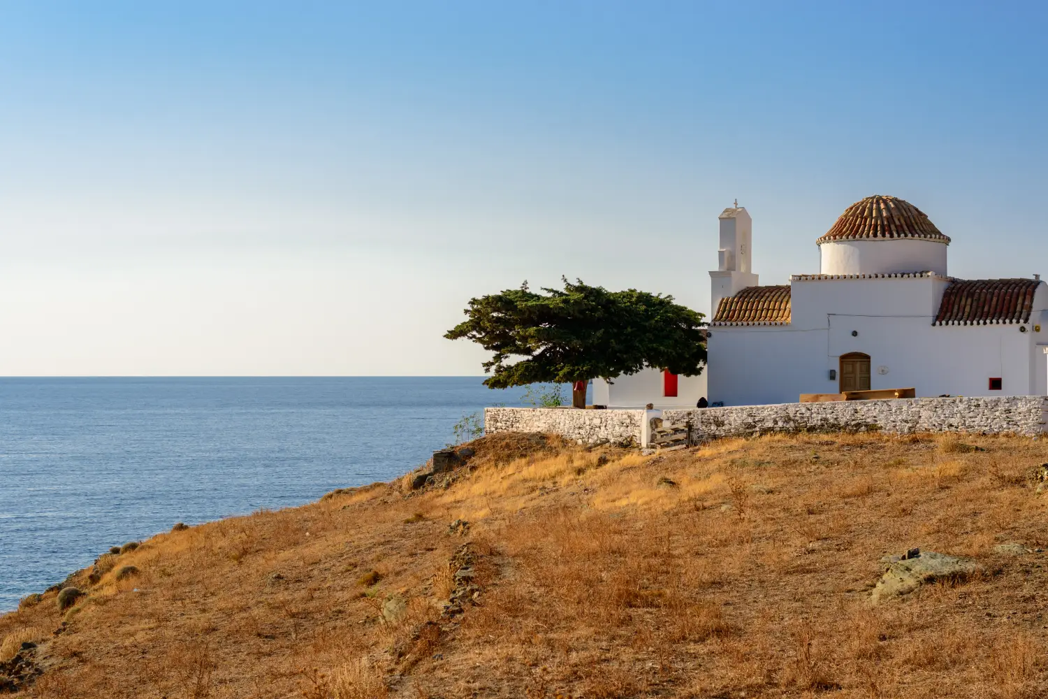 Ferry to Kythnos - Small church of Panagia Flampouriani (the Virgin Mary of Flampouriani) with a tiled cupola at Flampouria in Kythnos, Greece.