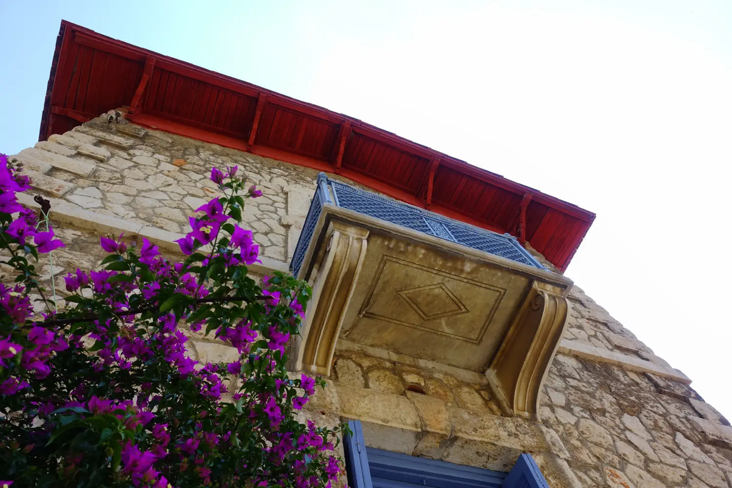 Ferry to Piraeus - Photo from neoclassic building near port of Piraeus with beautiful bougainvillea flower in blossom, Attica, Greece.