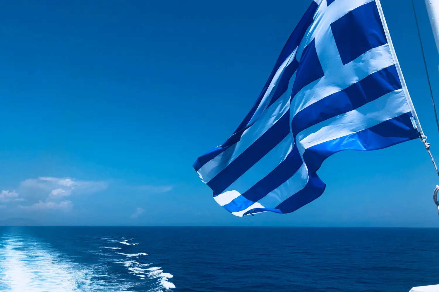 Greek ferries - Greek flag on ferry, traveling to Greek Islands