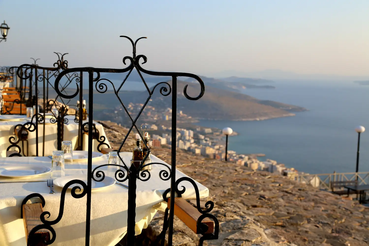 Ferry to Saranda - Romantic interior in the top roof restaurant in Saranda in Albania. Panoramic view from Lecursi castle.