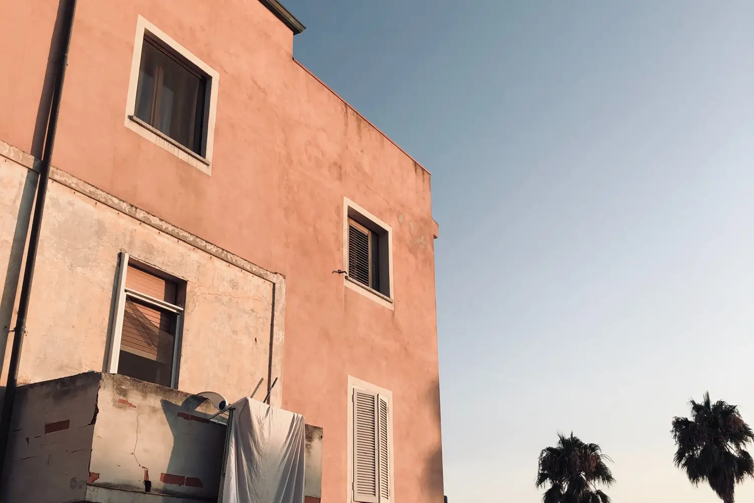 Ferry to Golfo Aranci - Dusky scenery is leaving playful its light marks on an old building.