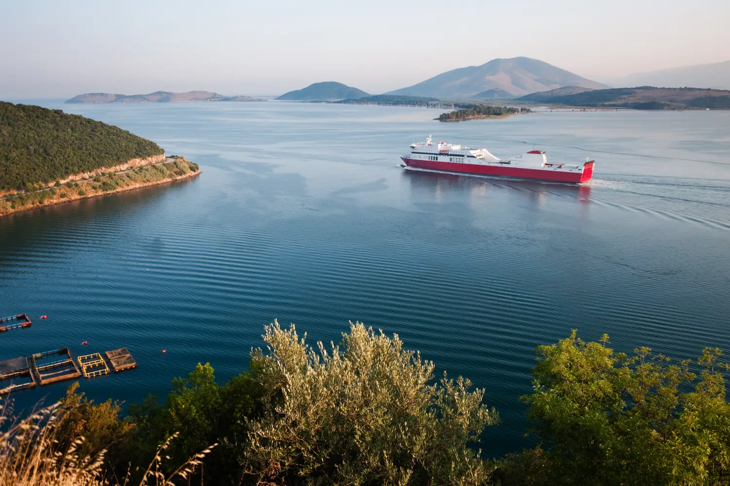 Ferry to Igoumenitsa - Red ferryboat navigate in the Gulf of Igoumenitsa to arrive in Italy.
