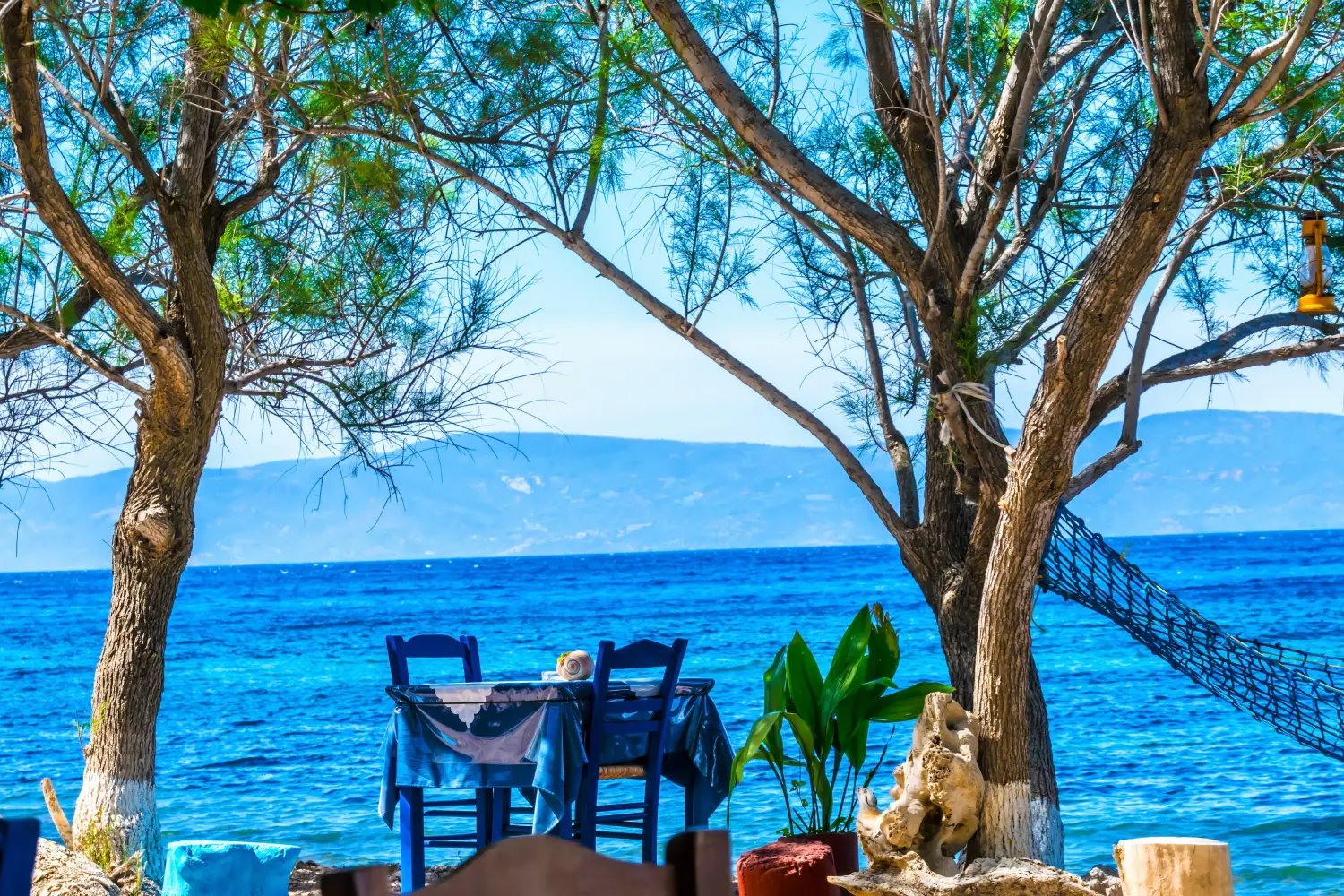 Ferry to Lesvos - A beautiful sitting place in the shade in the Aegean Sea on the island of Lesbos directly by the sea with a view of Turkey.