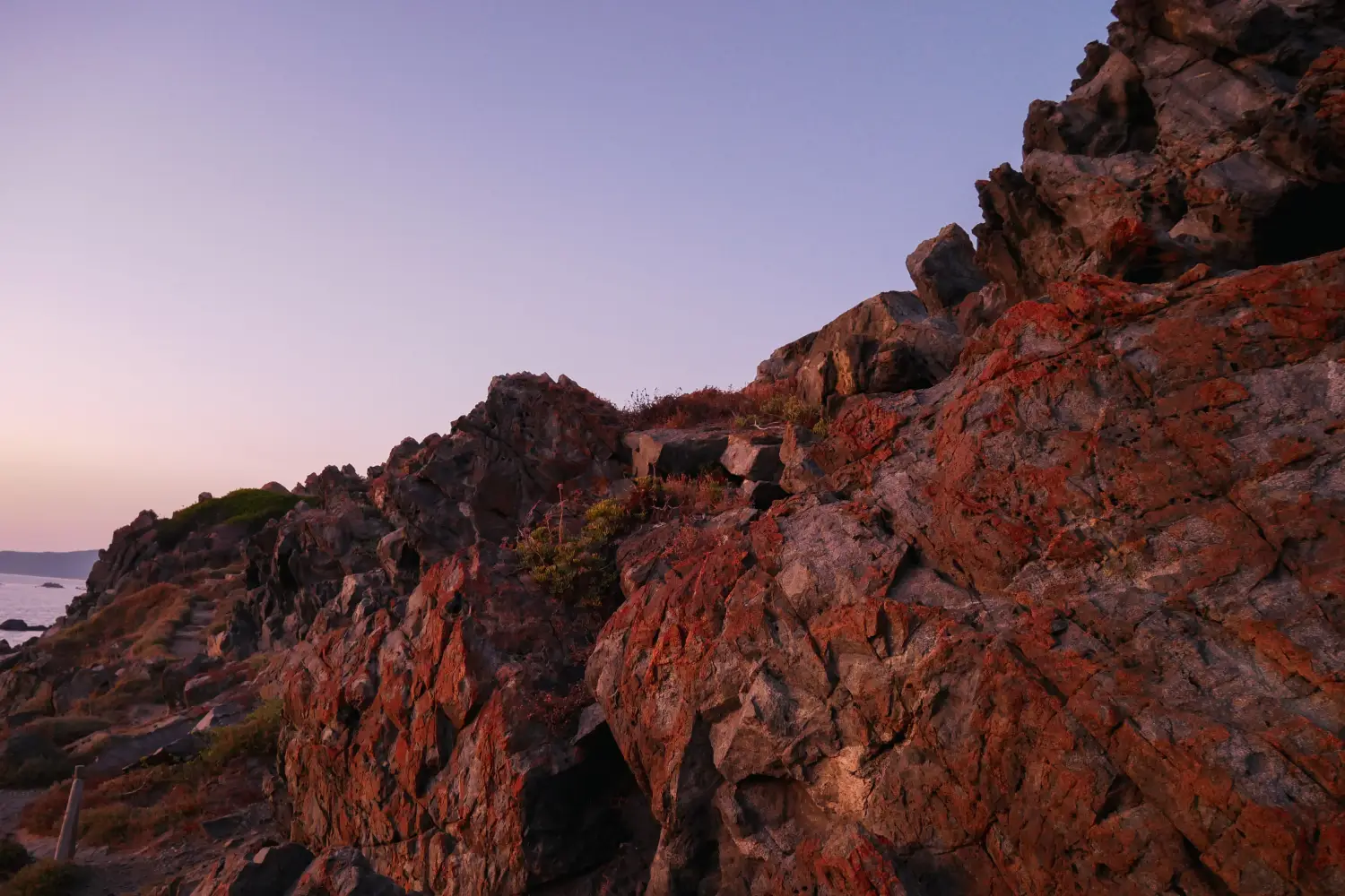 Ferry to Ajaccio - Red colored cliffs at the sea.