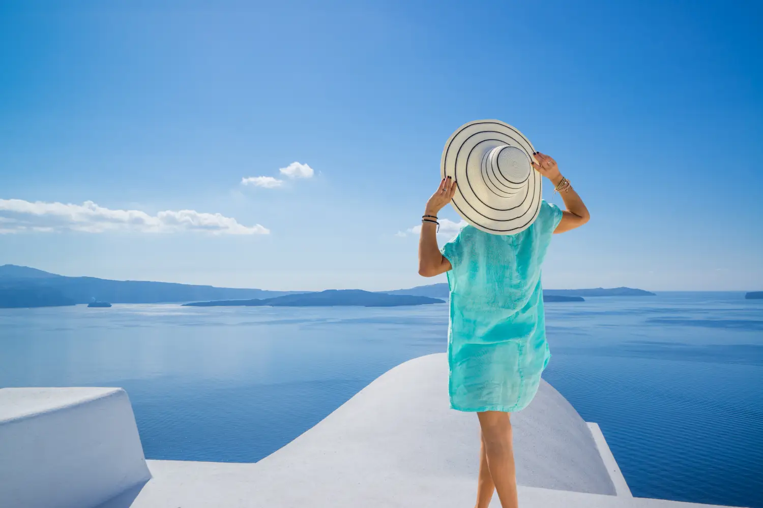 Ferry to Greece - Young woman on holidays, Santorini, Oia town, Greece.