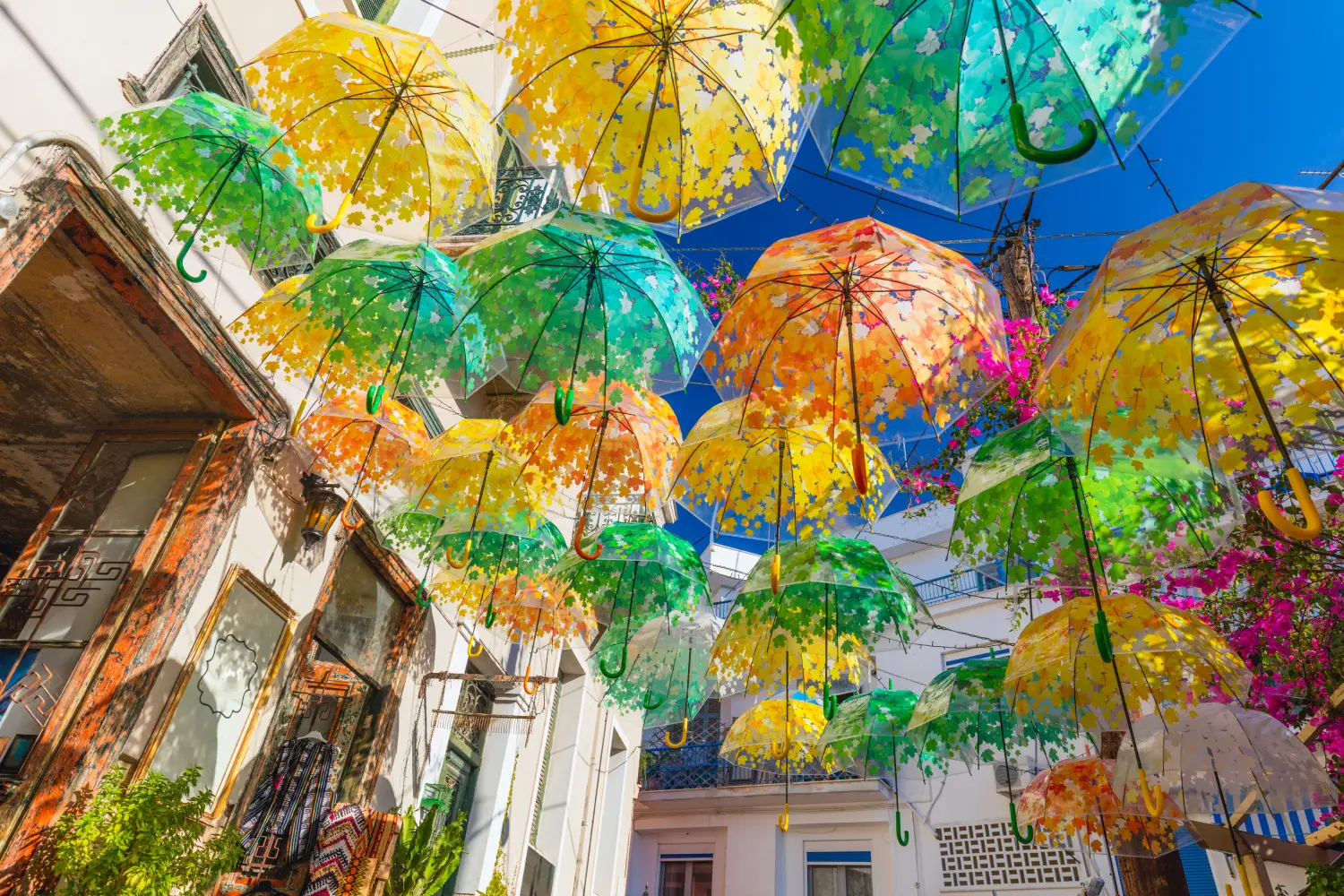 Ferry to Aegina - Colorful umbrellas hanging over a small piazza.