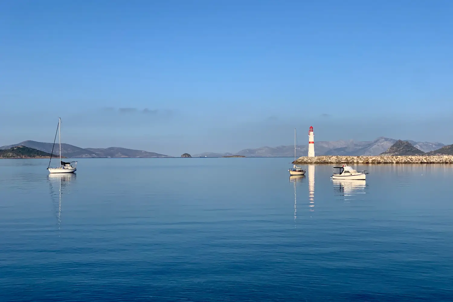 Ferry to Turgutreis - Calm sea and a lighthouse, surrounded by fishing boats.