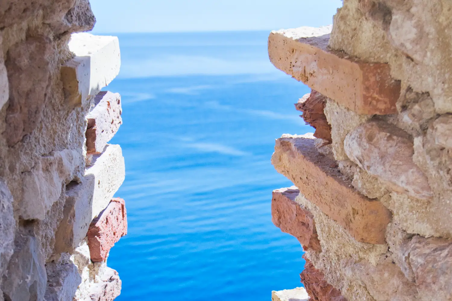 Ferry to Tremiti Islands - view of Tremiti islands from window with blue water.