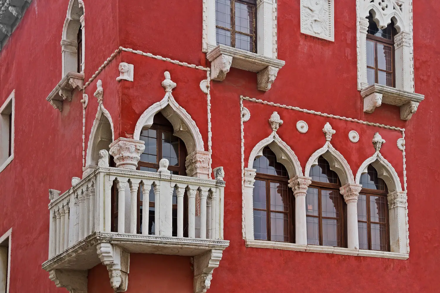 Ferry to Pirano - House fragment in the Venetian style with characteristic windows and a balcony, Piran, Slovenia.